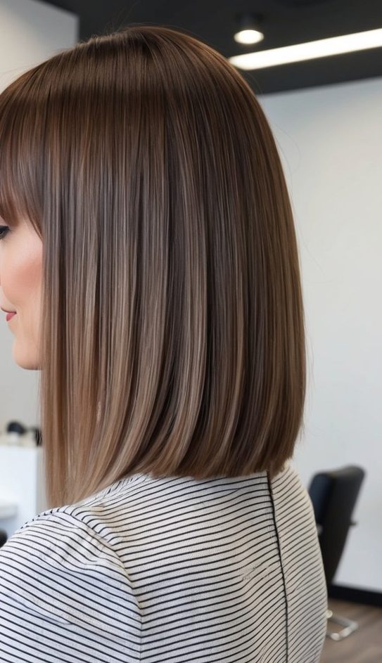 Precision long bob with thick blunt fringe and straight-across razor tips, ideal for straight hair cuts.